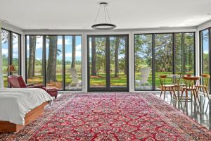 a bedroom with a bed and a table and chairs at The Porter's Barn - fancy little waterfront home with deep-water boat dock and firepit in New Church +33 photos