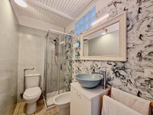 a bathroom with a sink and a toilet and a mirror at La Voltellina OLTRE HOME HOLIDAYS in Sanremo +25 photos