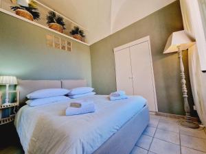 a bedroom with a large bed with towels on it at La Voltellina OLTRE HOME HOLIDAYS in Sanremo