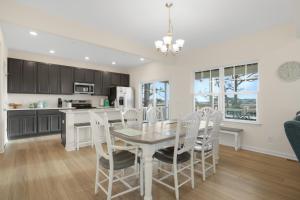 a kitchen and dining room with a table and chairs at Robert's Retreat - Brand new home w/ gorgeous water views! in Greenbackville