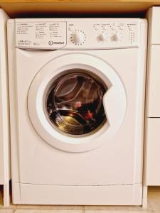 a white washer and dryer in a kitchen at La Voltellina OLTRE HOME HOLIDAYS in Sanremo