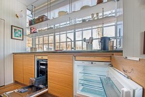 a large kitchen with an open dishwasher at Renovated, Modern Downtown Loft in Provincetown