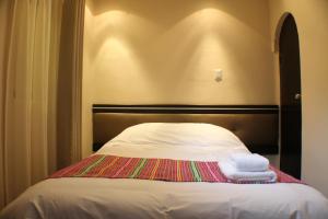 Voodi või voodid majutusasutuse Tampu Hotel toas
