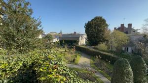 a view of a garden with trees and houses at Maison 4 chambres près d Angers et à 500 m de la Loire in Sainte-Gemme-sur-Loire