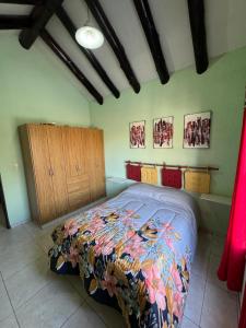 a bedroom with a bed with a colorful blanket at Duplex Aconcagua in Guaymallen