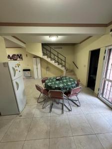 a room with a table and chairs and a refrigerator at Duplex Aconcagua in Guaymallen +14 photos