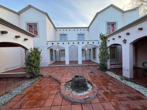 a large house with a courtyard with a fountain at Duplex Aconcagua in Guaymallen