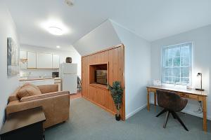 a living room with a couch and a desk at Jackson River Estate Studio Apartment on the River in Covington +6 photos