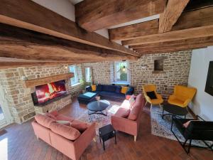 a living room with couches and a fireplace at Au Mont De La Quintine # Piscine & Jacuzzi # in Saint-Quentin-sur-le-Homme