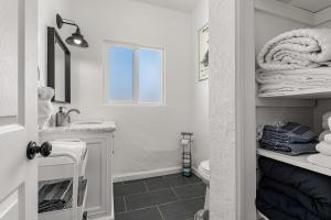a white bathroom with a sink and a toilet at Desert Artist Oasis- Firepit - Spa - 5 min to Joshua Tree in Yucca Valley +40 photos