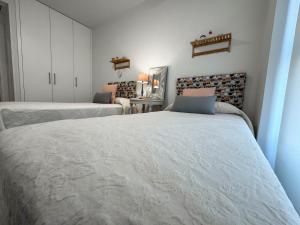 a bedroom with two beds in a room at Gold Beach in Almerimar +40 photos