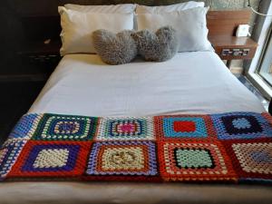 a bed with two teddy bears on top of it at Urban Villa 25 in Gaborone +28 photos
