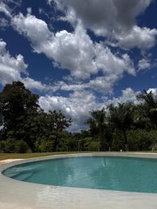 an empty swimming pool with a cloudy sky at Villa Dois Amores in Lindóia +19 photos