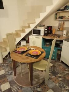 a dining room table with two chairs and a staircase at L'insolite et médièvale Tour Yselda in Saint-Pourçain-sur-Sioule +40 photos