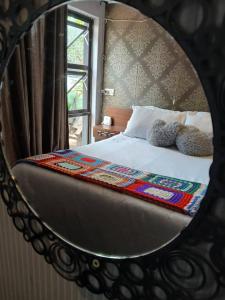 a mirror reflection of a bed in a bedroom at Urban Villa 25 in Gaborone
