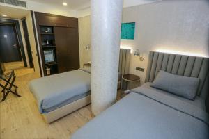 Postel nebo postele na pokoji v ubytování Milord Hotel