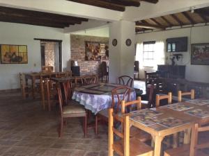 a dining room with wooden tables and chairs at DOFA Hosteria in Villa de Leyva