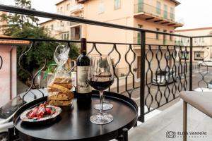 a table with a glass of wine and some food at Corallo Blu a pochi passi dal mare! in Rosignano Solvay