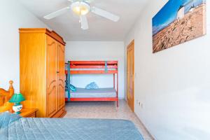 a bedroom with a bed and a ceiling fan at Apartamento con Vista al Mar in Roquetas de Mar