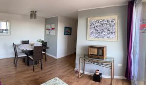 a living room with a table and a dining room at Departamento Amoblado Centro de Talca in Talca +17 photos