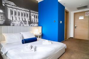Postel nebo postele na pokoji v ubytování Hotel Passport