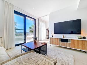 a living room with a large flat screen tv at La Llana Beach MDC - 5610 in Mar de Cristal