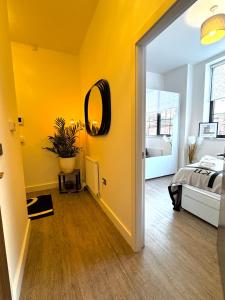 a yellow room with a bed and a mirror at Chester's - Central Chester Stays - 2 Cuppin Street - 2 Minute Walk From Shops in Chester