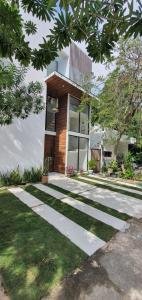 a house with a walkway in front of it at Casa Luz in Puerto Morelos