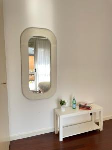 a white room with a mirror and a table at La casa di Erika in Almè