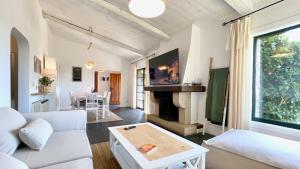 a living room with a white couch and a fireplace at The Cliffs - Vue de Pantin in Valdoviño
