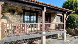 a porch of a stone house with a balcony at The Cliffs - Vue de Pantin in Valdoviño