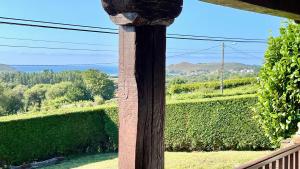a view from a porch with a wooden pole at The Cliffs - Vue de Pantin in Valdoviño +28 photos