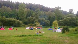 a group of people in a field with tents at Lávka 222 in Chocerady