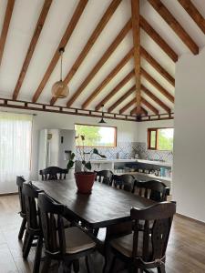 a dining room with a large wooden table and chairs at Casa Silvestre in Villa de Leyva