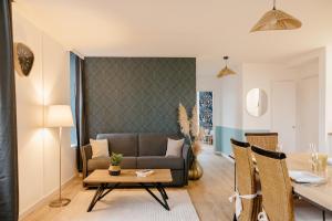 a living room with a couch and a table at L'Atelier du Pont in Guichen