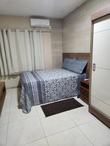 a small bedroom with a bed and a dresser at Casa Aconchegante em Condomínio Country in Conde +44 photos