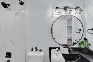 a bathroom with a sink and a mirror at You will love this 2BR Guest Suite in SE Calgary in Calgary +55 photos