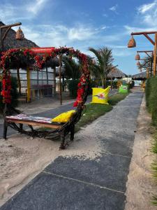 a bench with flowers on it on a street at Pousada Villa Al Mare in Luis Correia