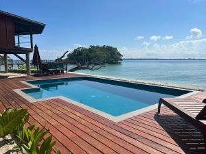 a swimming pool on a deck next to the water at Exclusive Sunrise Boutique Resort & Private Island- Adults Only - All Inclusive Intimate Island & Santo Experience for Only 9 Couples at a Time in Saraotou