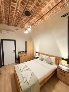 a bedroom with a large bed with a brick ceiling at Taksim Millennium Alkan Residence in Istanbul