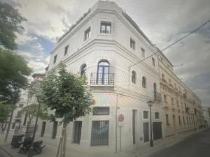 a large white building on a city street at apartamentos montevideo 6 in Seville