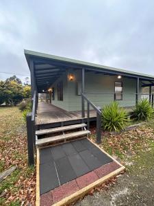 a house with a wooden deck in front of it at Beaufort Cottage Retreat Oaks on Havelock in Beaufort