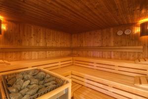 an empty wooden sauna with rocks in it at Best Western Hotel San Marco in Siena
