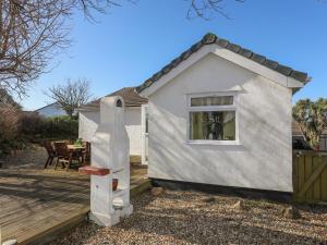 a house with a statue of a man on a deck at Tegfan in Holyhead