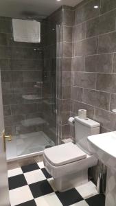 a bathroom with a shower and a toilet and a sink at Best Western Brook Hotel in Felixstowe