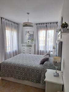 En eller flere senge i et værelse på ATICO VISTA ESURI GOLF y RELAX