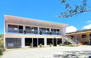 an exterior view of a building with a staircase at Hostel Cattleya - Monteverde, Costa Rica in Monteverde Costa Rica