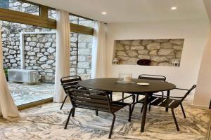 a table and chairs in a room with a stone wall at Studio in Antibes near La Salis Beach in Antibes