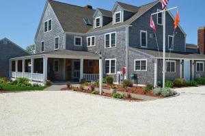 a large house with a flag in the driveway at Beach Breeze Inn in Falmouth