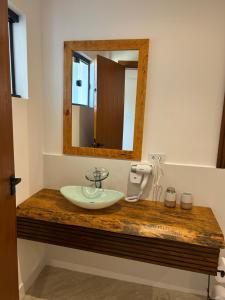 a bathroom with a sink and a mirror at Maluhia Ilhabela 1 in Ilhabela +23 photos